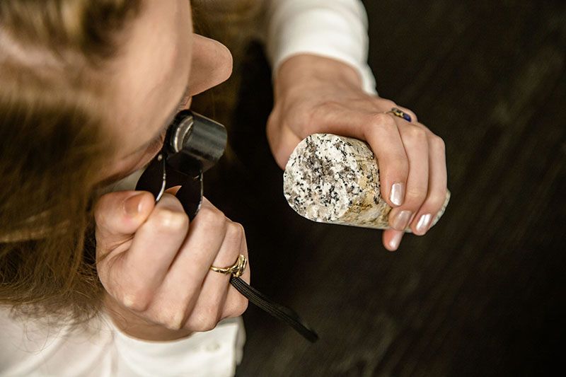 geological consultant examining rock core sample