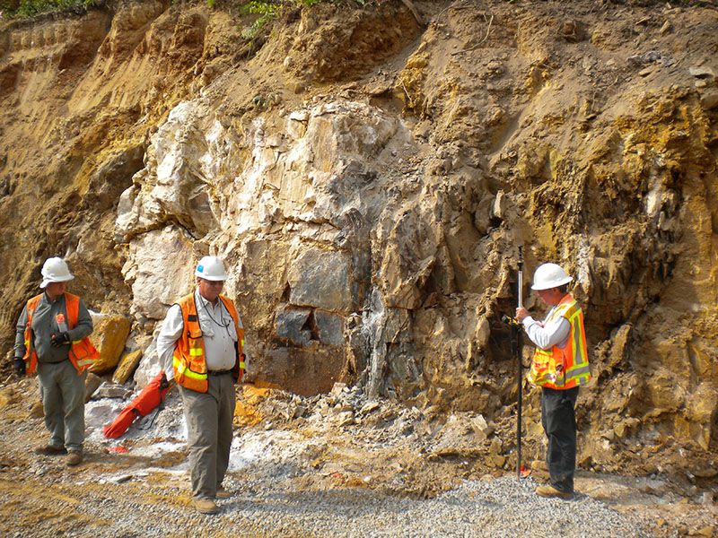 Geological engineers mapping rock quarry